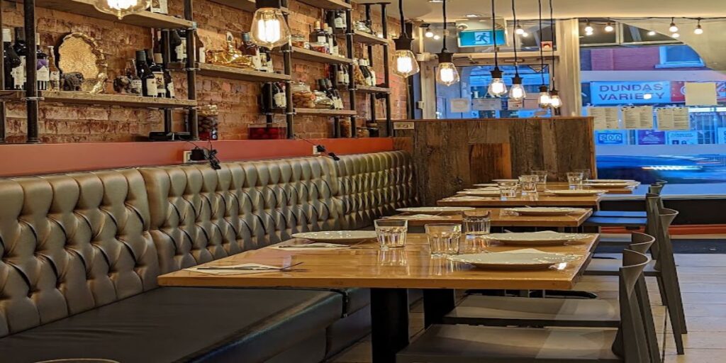 A restaurant with tables and chairs in the middle of the room.