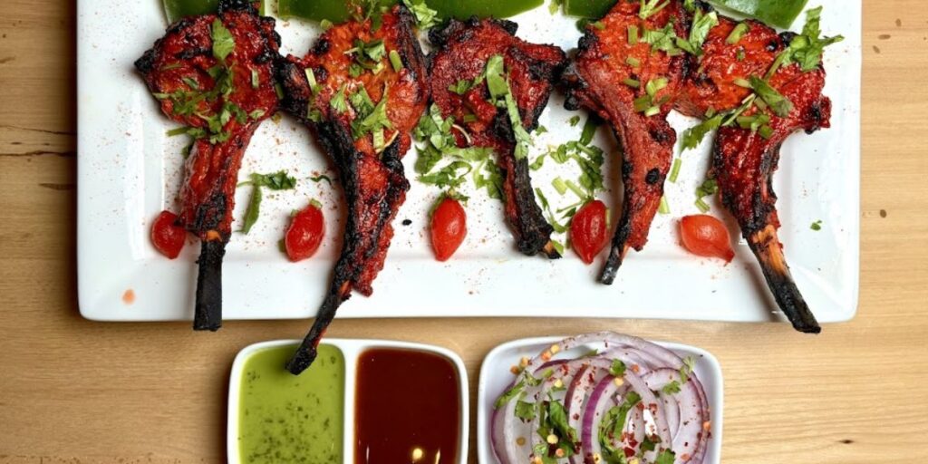 A plate of tandoori chicken skewers with vibrant colors from turmeric and paprika, cooked in a clay oven for a charred, smoky flavor.