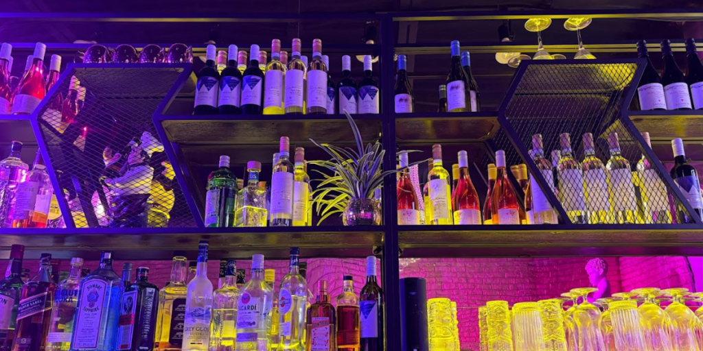 2. Assorted alcohol bottles lined up on bar shelves. Where to Enjoy: Best Places in Toronto.
