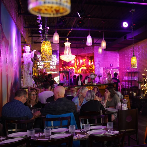 A vibrant restaurant scene on Gerrard Street, where guests indulge in diverse culinary offerings and enjoy each other's company.