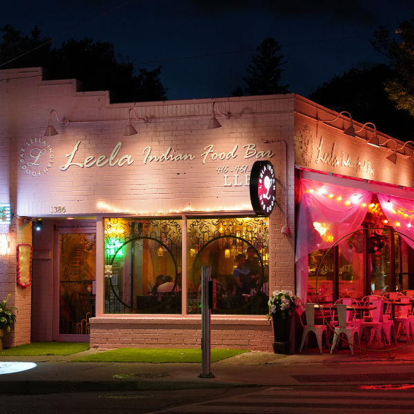 A vibrant restaurant on Gerrard Street featuring a neon sign, showcasing the diversity of Indian cuisine.